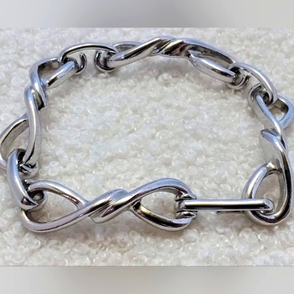 Avon Jewelry - Vintage Avon Silvertone Infinity Knot Panel Bracelet 8 in